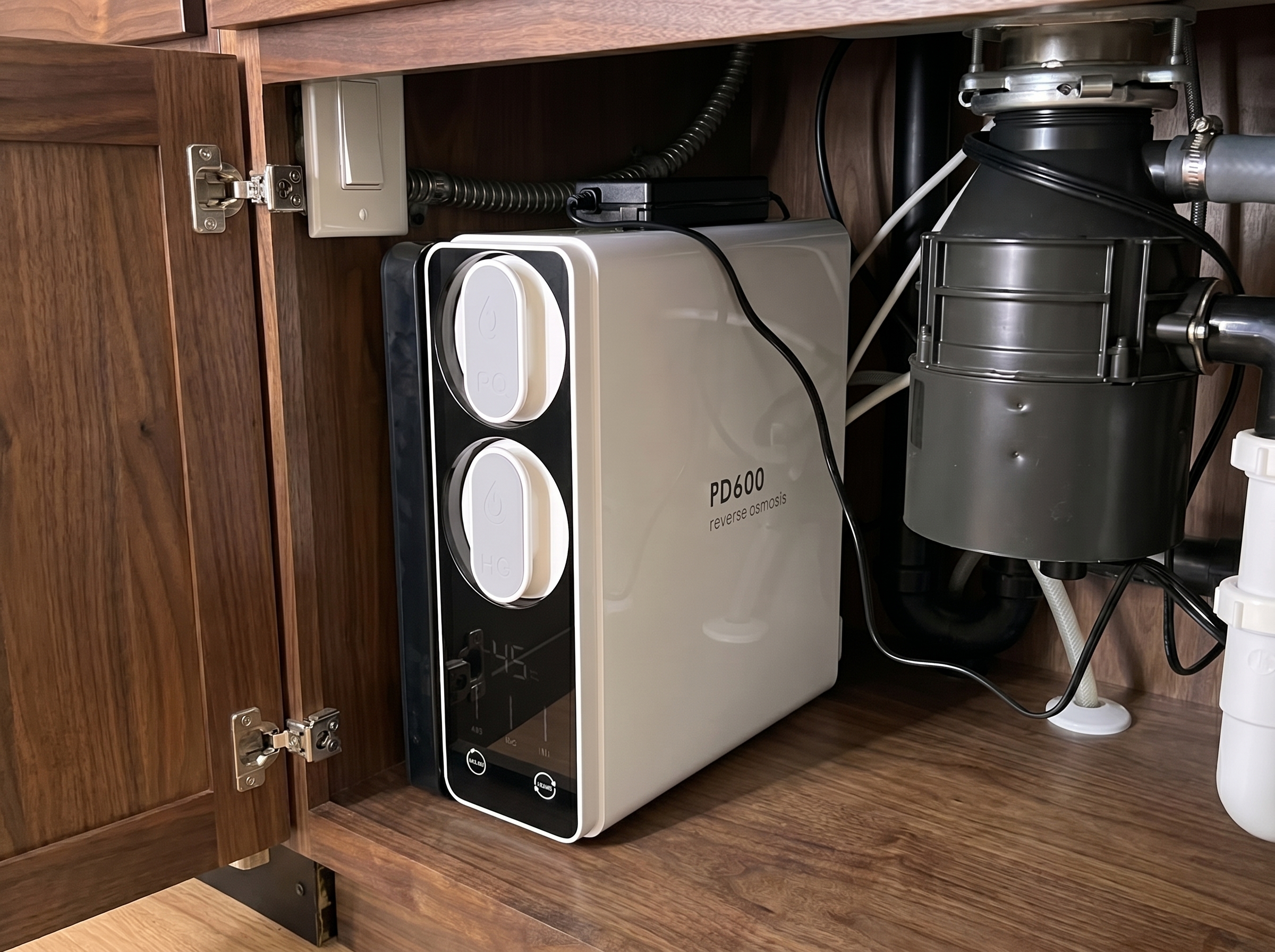 Frizzlife PD600 reverse osmosis system installed under kitchen sink — TDS display reading 45 PPM on North Alabama water, garbage disposal visible to the right